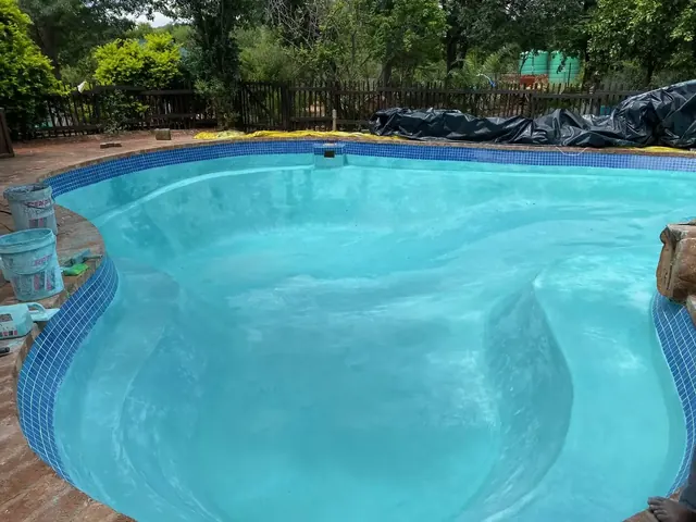 Freeform swimming pool refinished with a cement-based pool coating, Gaborone, Botswana